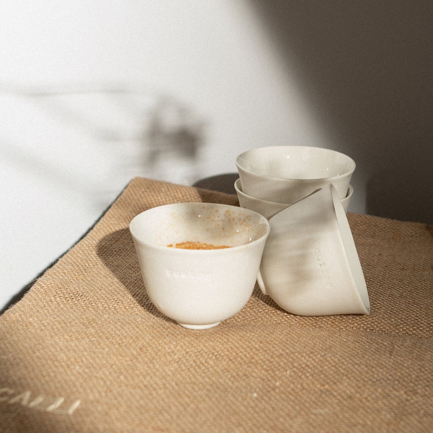 white espresso cups and jute table runner