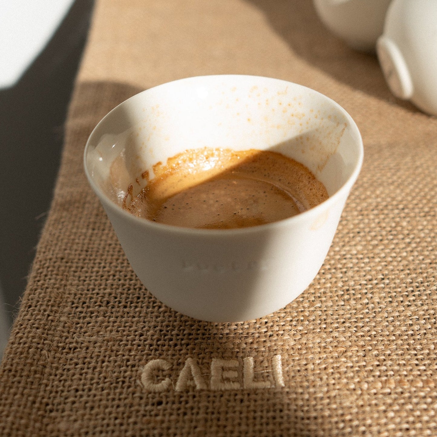 white espresso cup with the word poetry