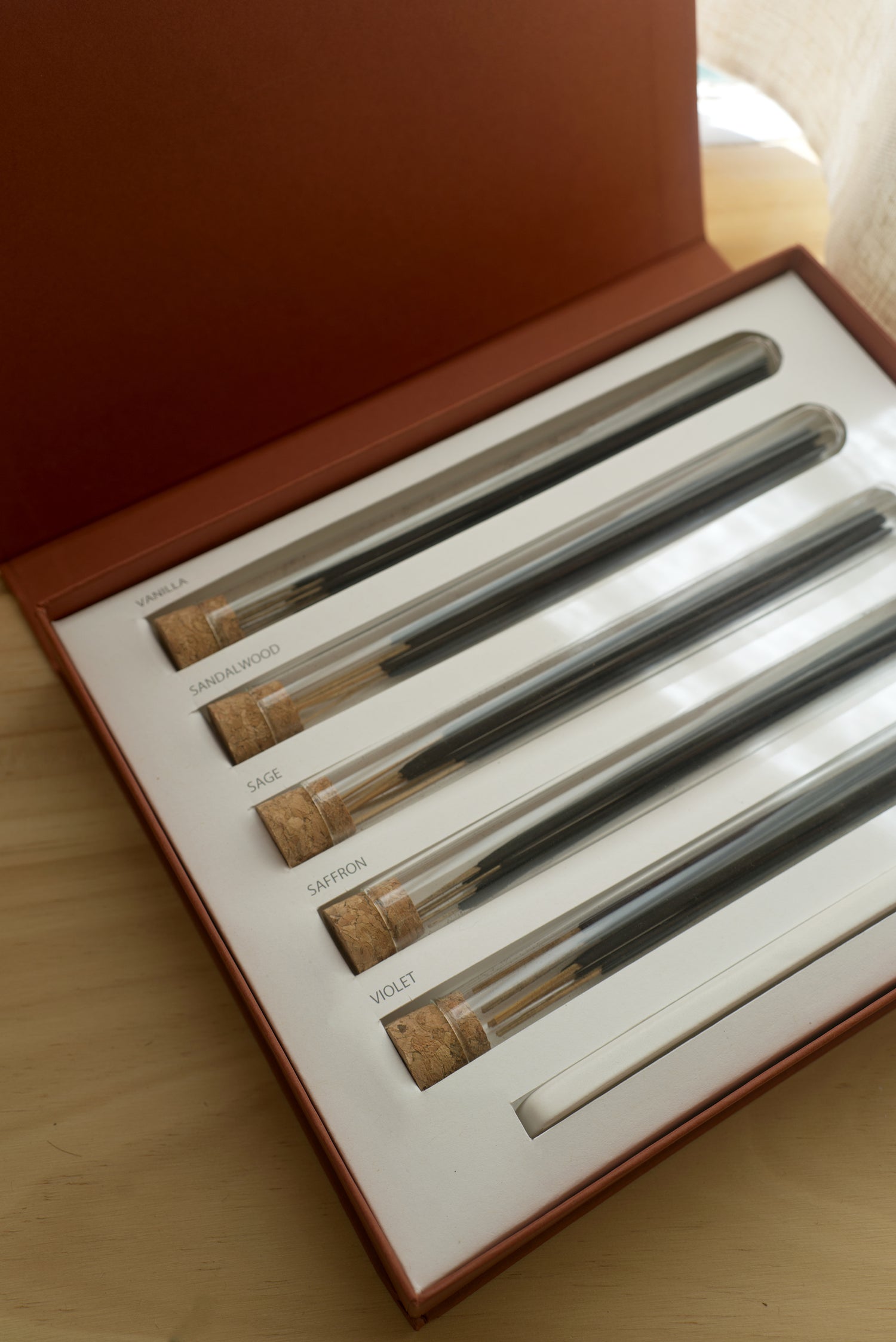 evening rituals box opened with a focus on the glass tubes containing the incense