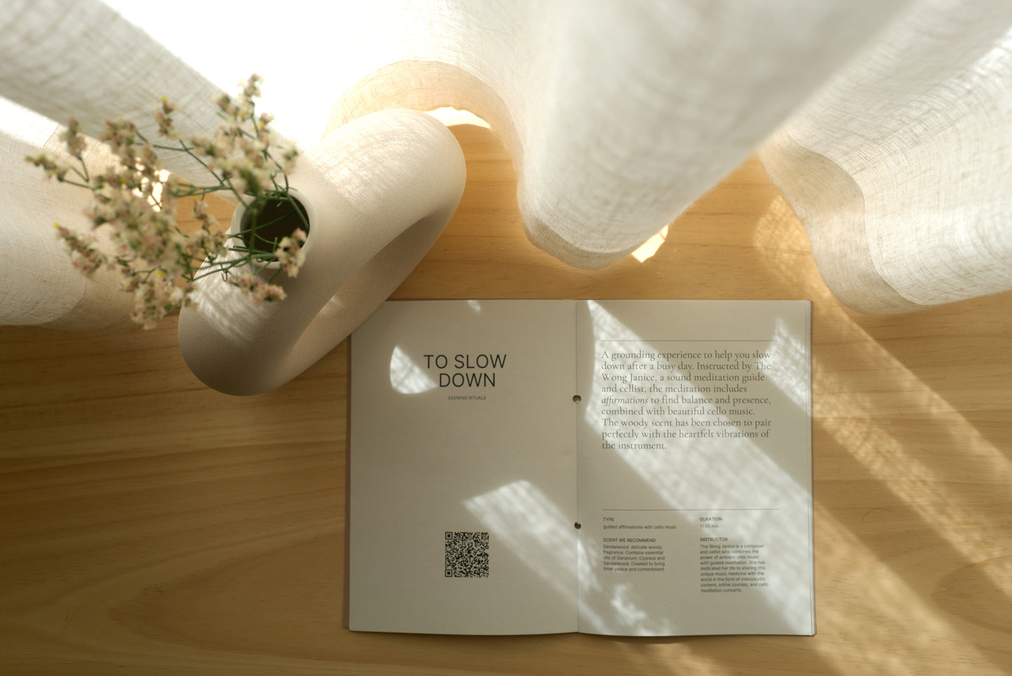 booklet opened next to a vase with flowers