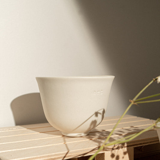 white porcelain espresso cup with a shadow
